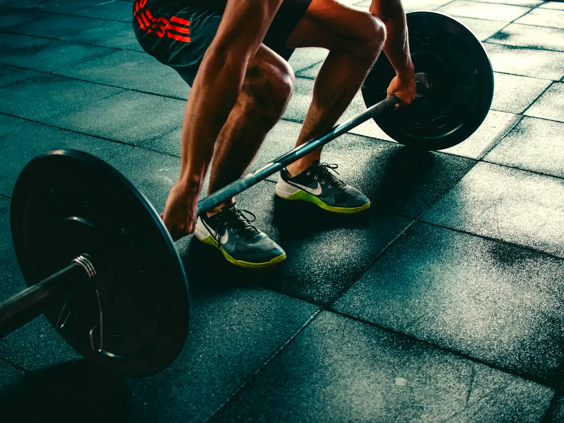 Barbell training on a gym floor